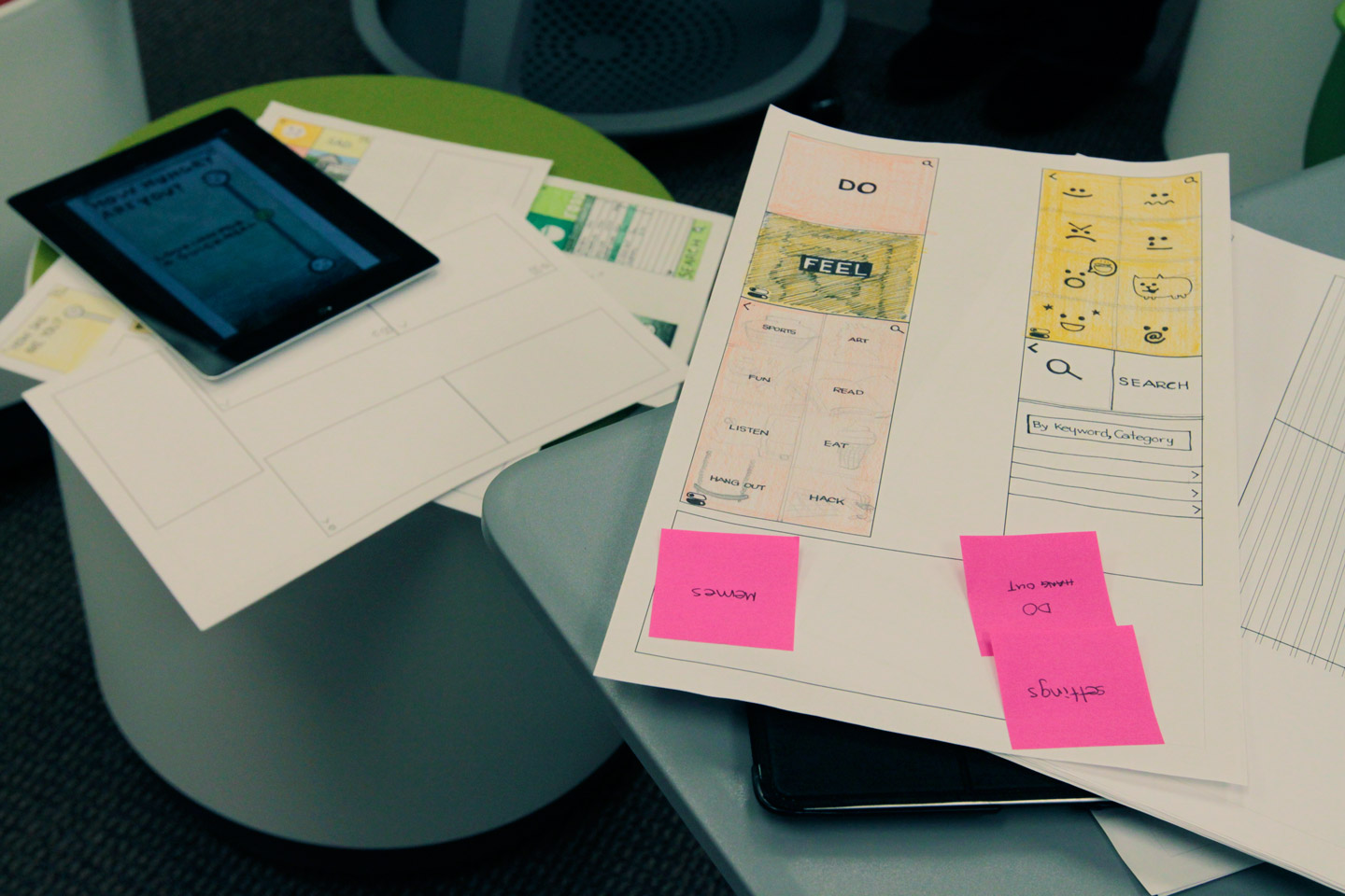 Sketches of app layouts and an iPad sitting on stools