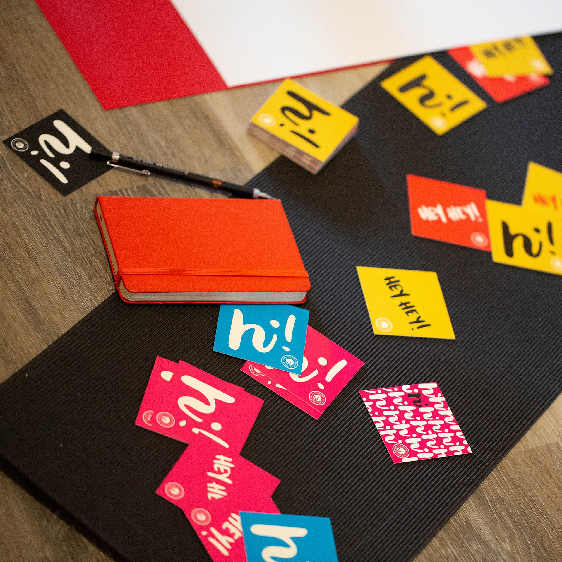 Colorful square cards scattered on a piece of black paper 