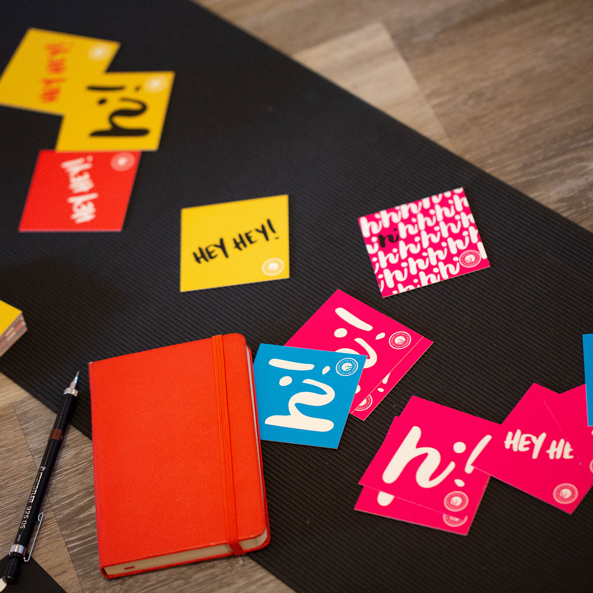 Colorful square cards scattered on a piece of black paper 