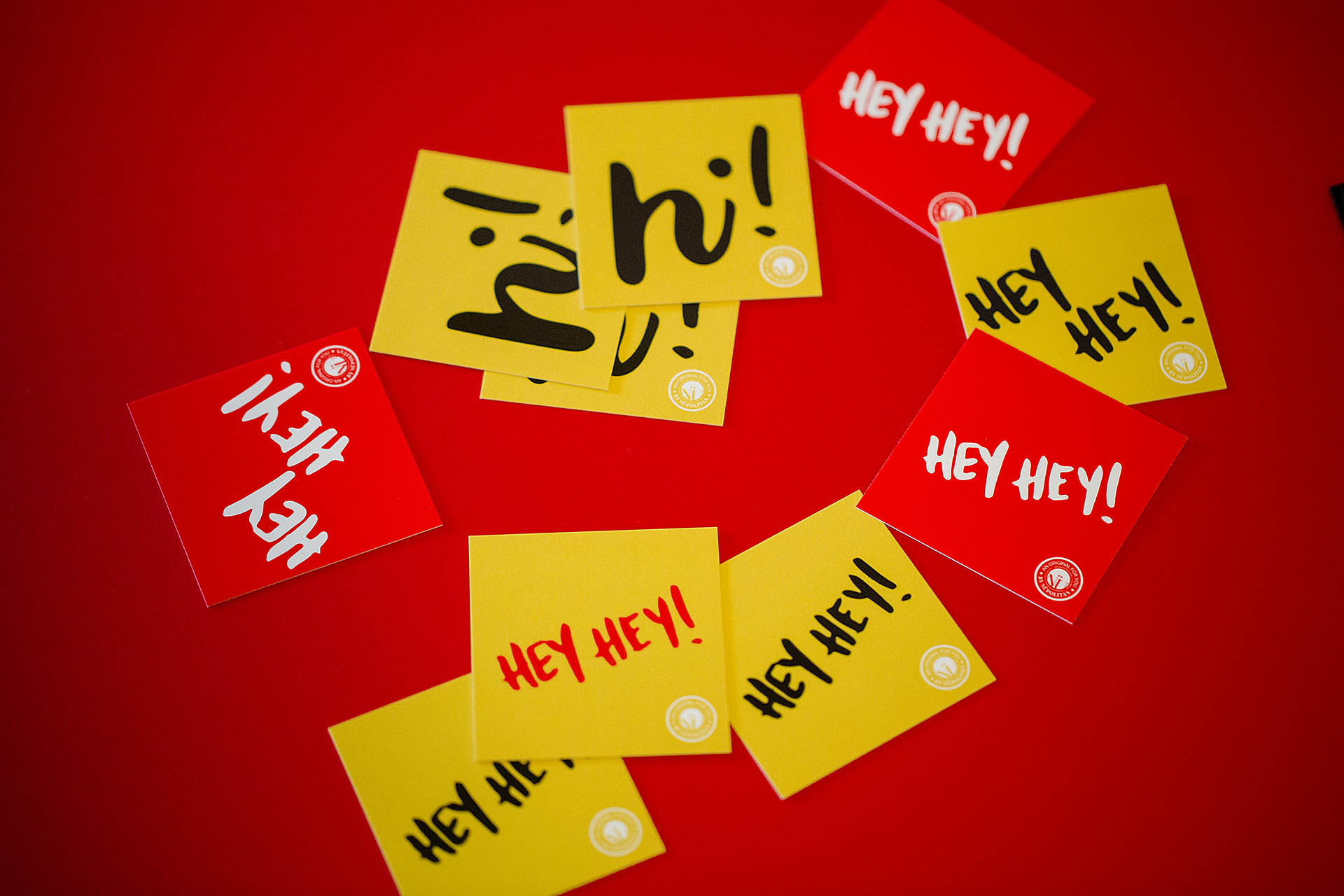 Red and yellow square cards scattered on a red background
