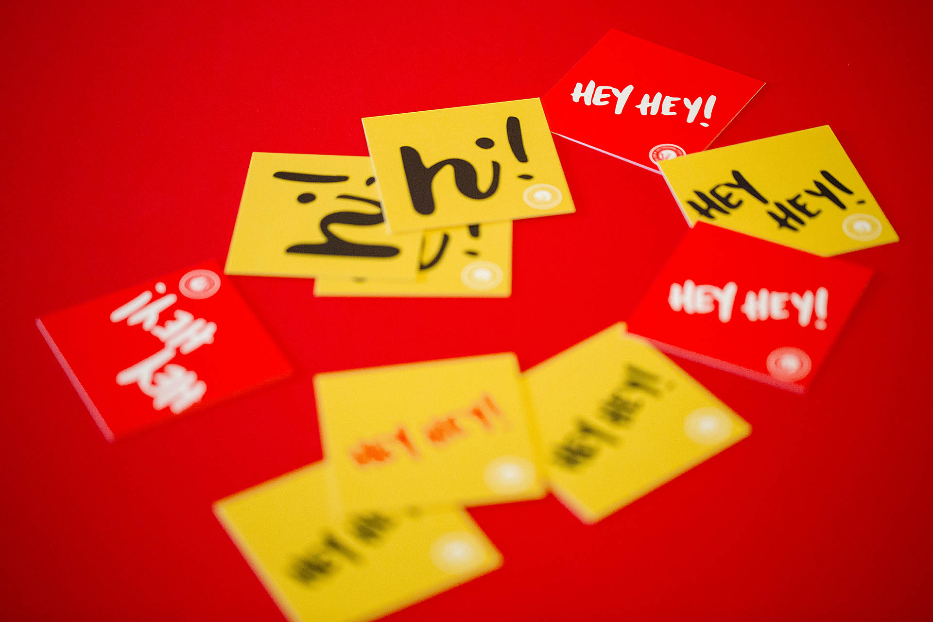 Red and yellow square cards scattered on a red background