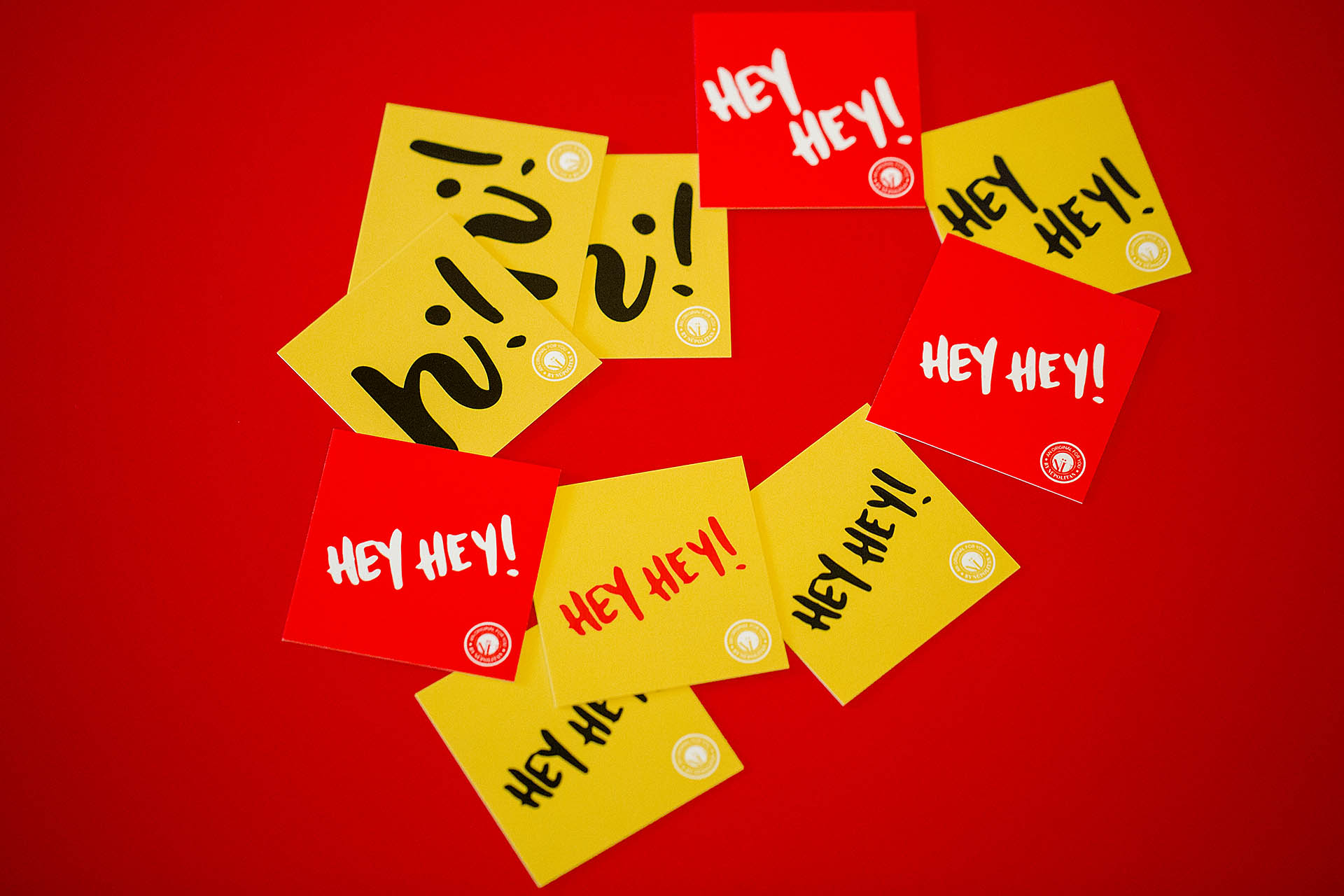 Red and yellow square cards scattered on a red background