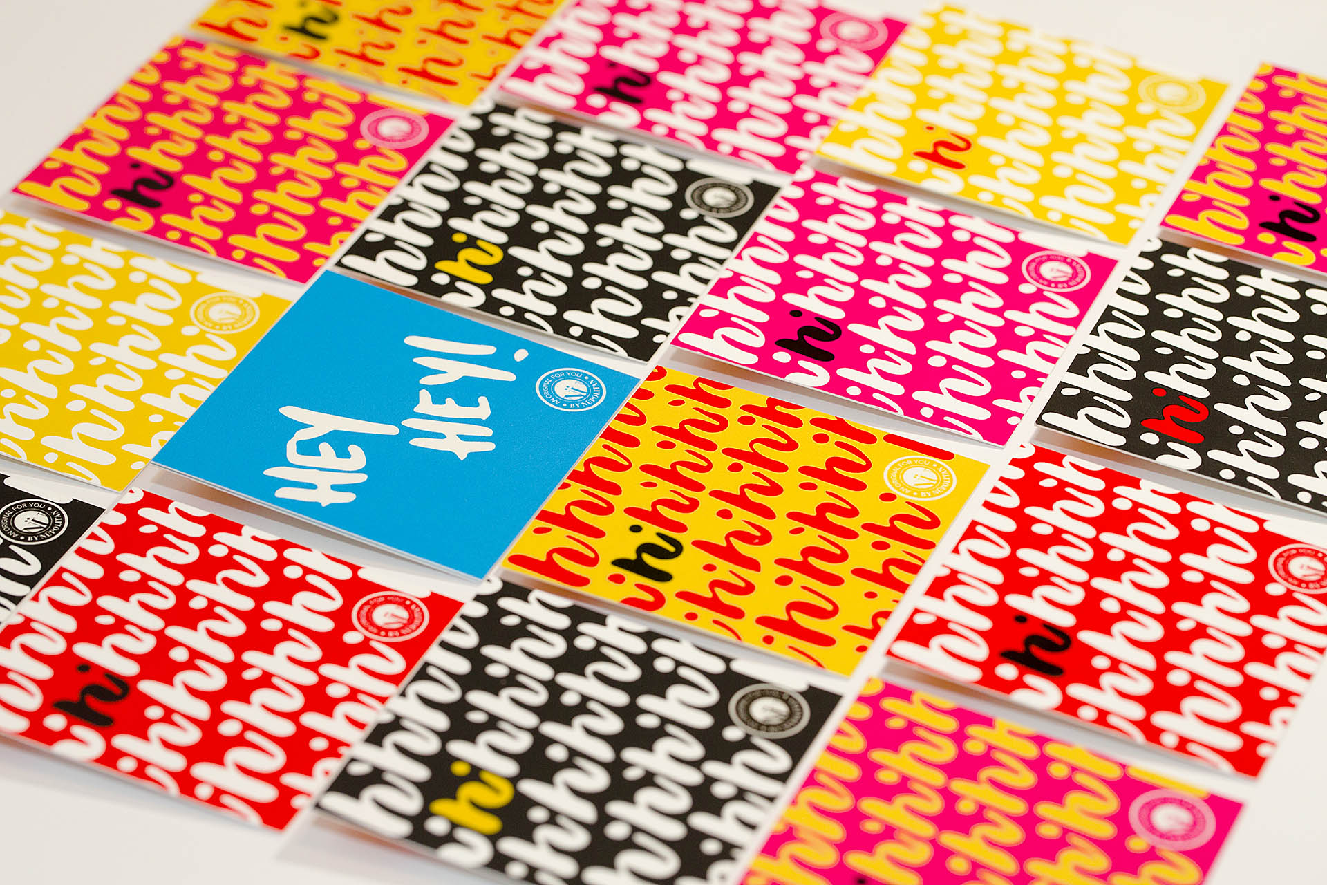 An isometric grid of 16 square, colorful cards on a white background