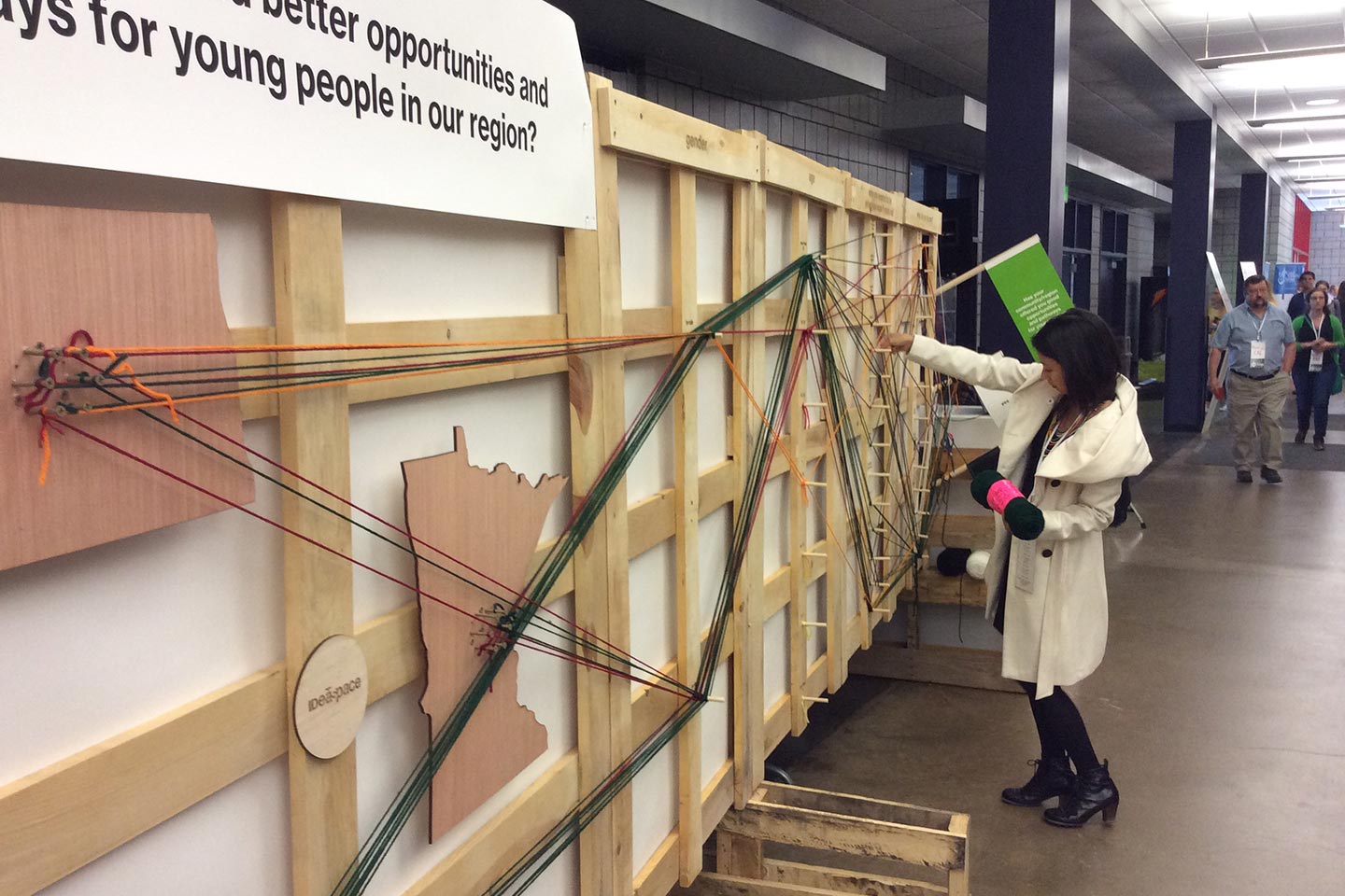 Woman interacting with wood and yard installation