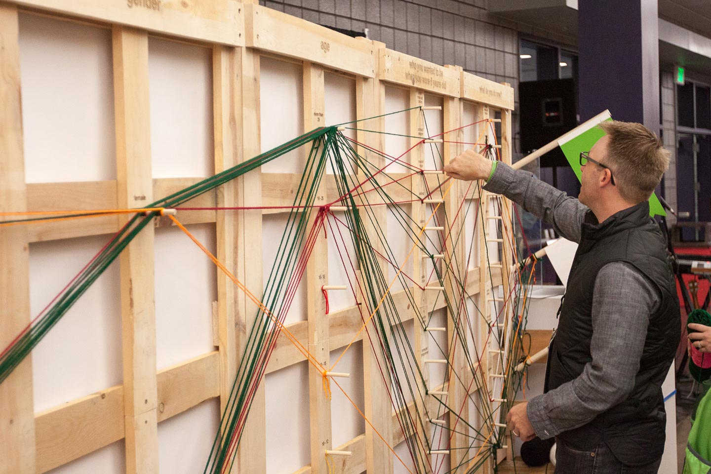 Man interacting with wood and yard installation