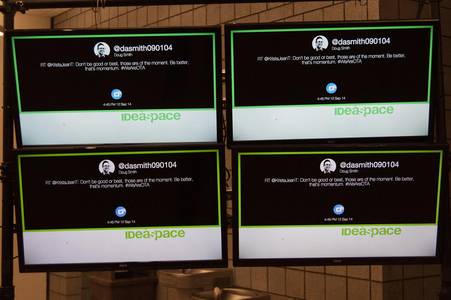 Four TV screens displaying interactive installation digital interface in black and white
