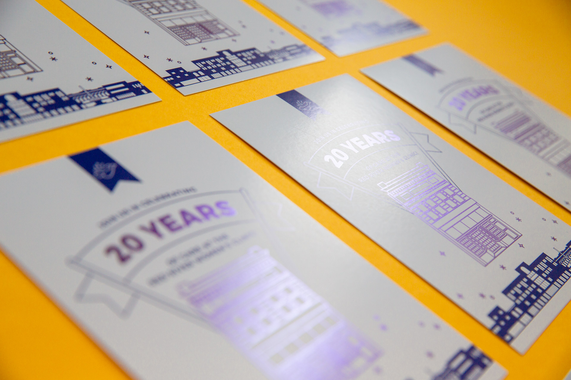 Grid of white postcards with purple illustration and lettering on a yellow background