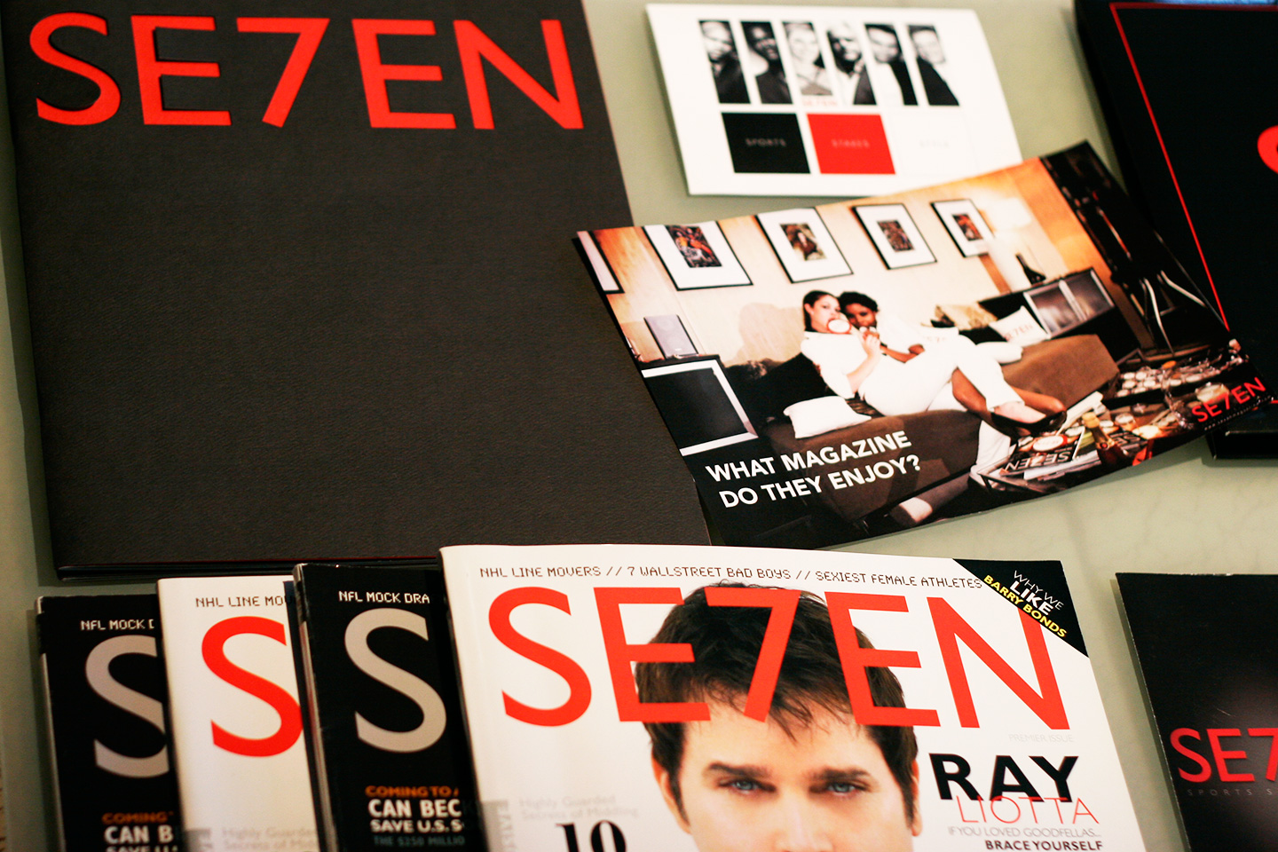 Stack of SE7EN magazines in black and red