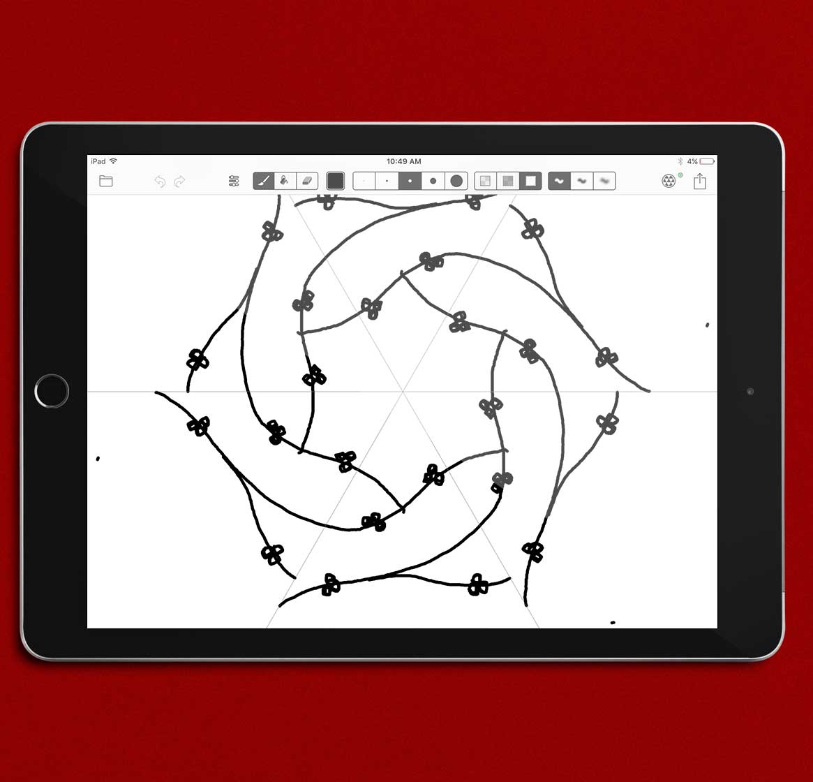 An iPad sitting on a red background displaying a circular pattern on its screen
